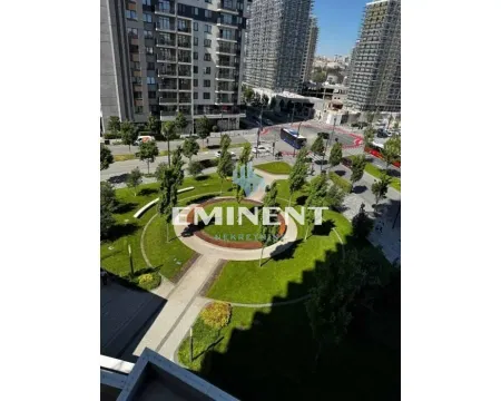 View from the window overlooking a landscaped park and city streets. - image 15