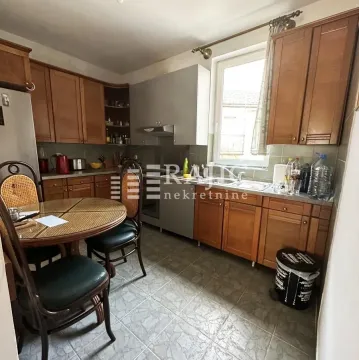 Kitchen with dining table and wooden elements. - image 4