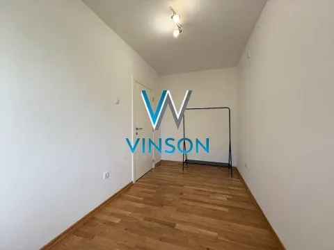 Empty room with wooden flooring and a clothing rack. - image 9