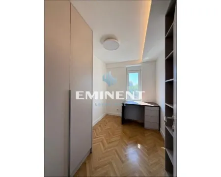 Small bedroom with fitted wardrobes, a desk, and parquet flooring. - image 14