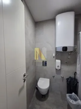 Modernly equipped bathroom with sanitary fixtures and a water heater. - image 11