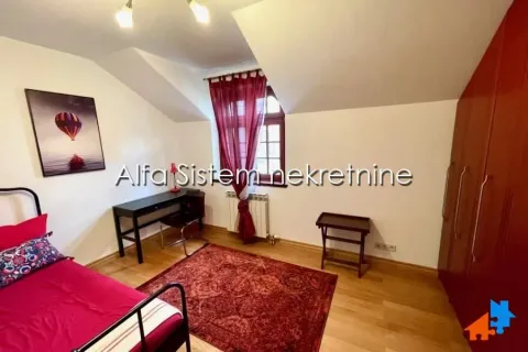 Furnished bedroom with a bed, wardrobe, and desk. - image 15