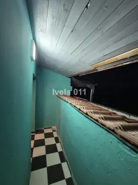 Covered balcony with checkerboard tile flooring and a wooden ceiling. - image 6
