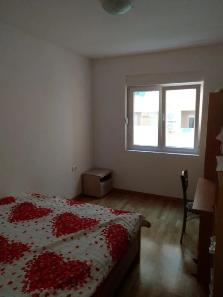 Bedroom with a double bed, desk, and a window.
