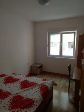 Bedroom with a double bed, desk, and a window. - image 9