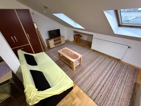 Attic living room with a sofa set, wardrobe and skylights. - image 7