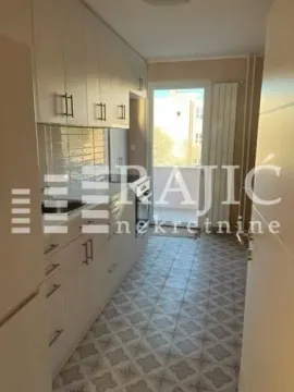 Small bright kitchen with white units and access to the terrace. - image 4