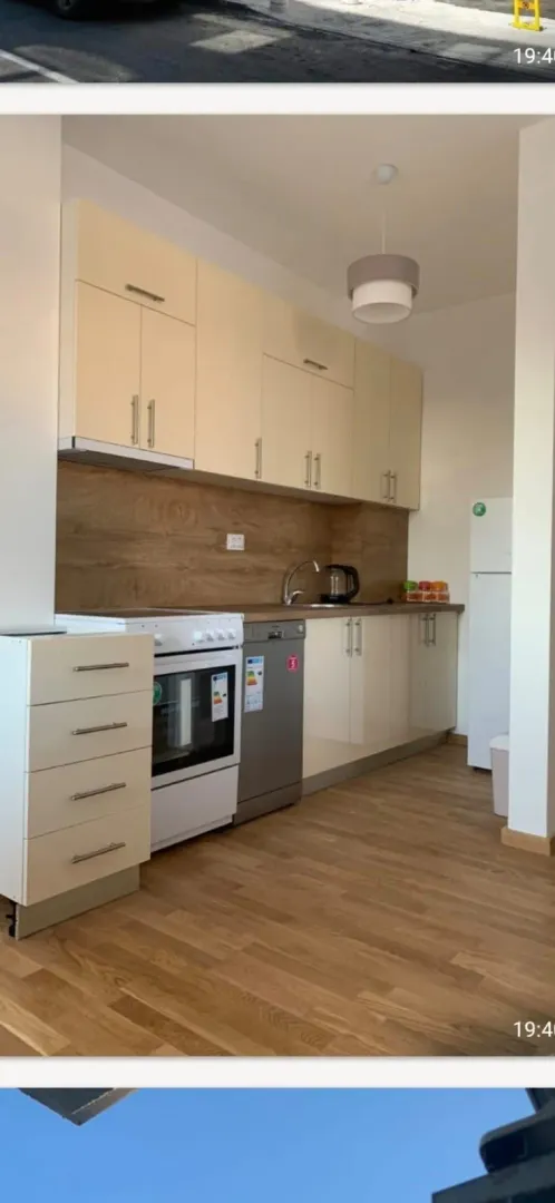 Kitchen with light cabinets and wooden countertops.