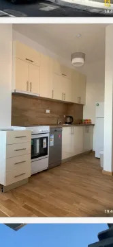 Kitchen with light cabinets and wooden countertops. - image 19