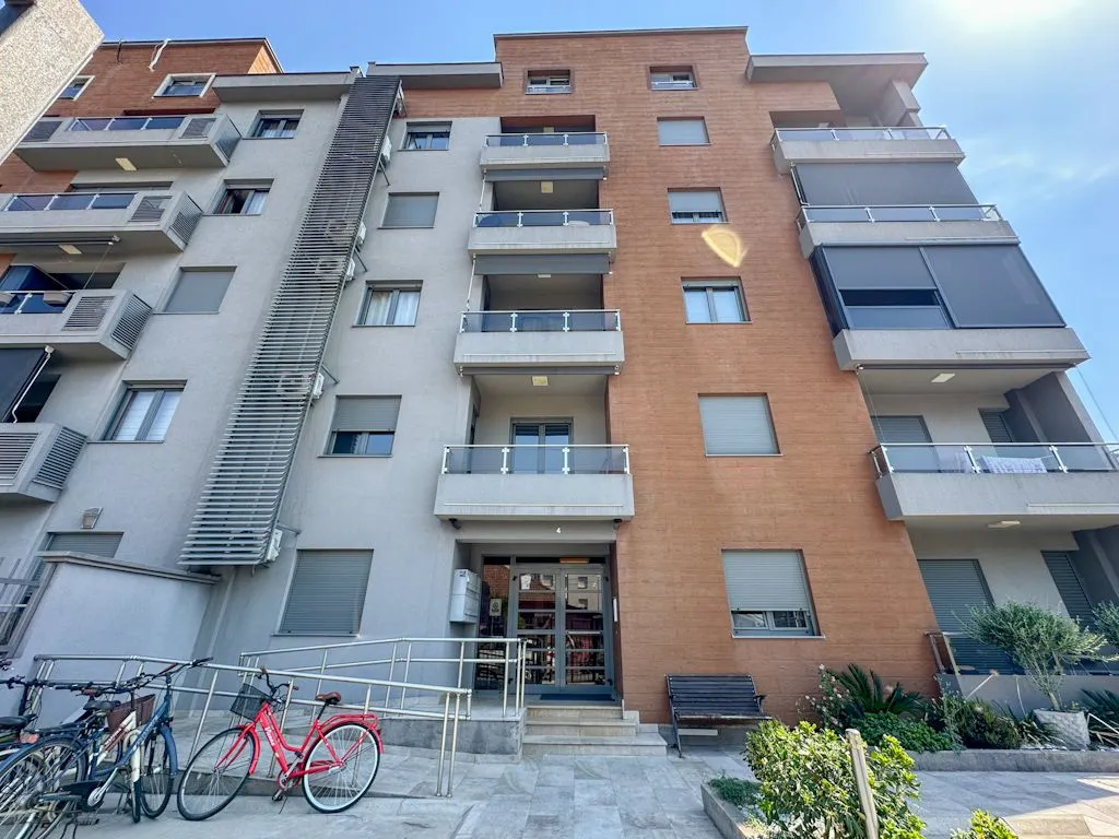 Facade of a modern residential building with balconies and entrance.
