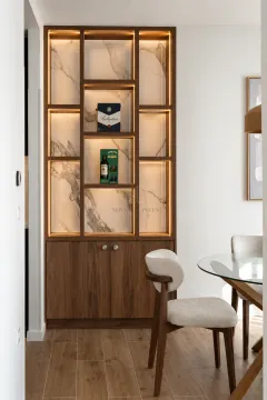 Wooden shelving unit with built-in lighting and a marble background in the interior. - image 8
