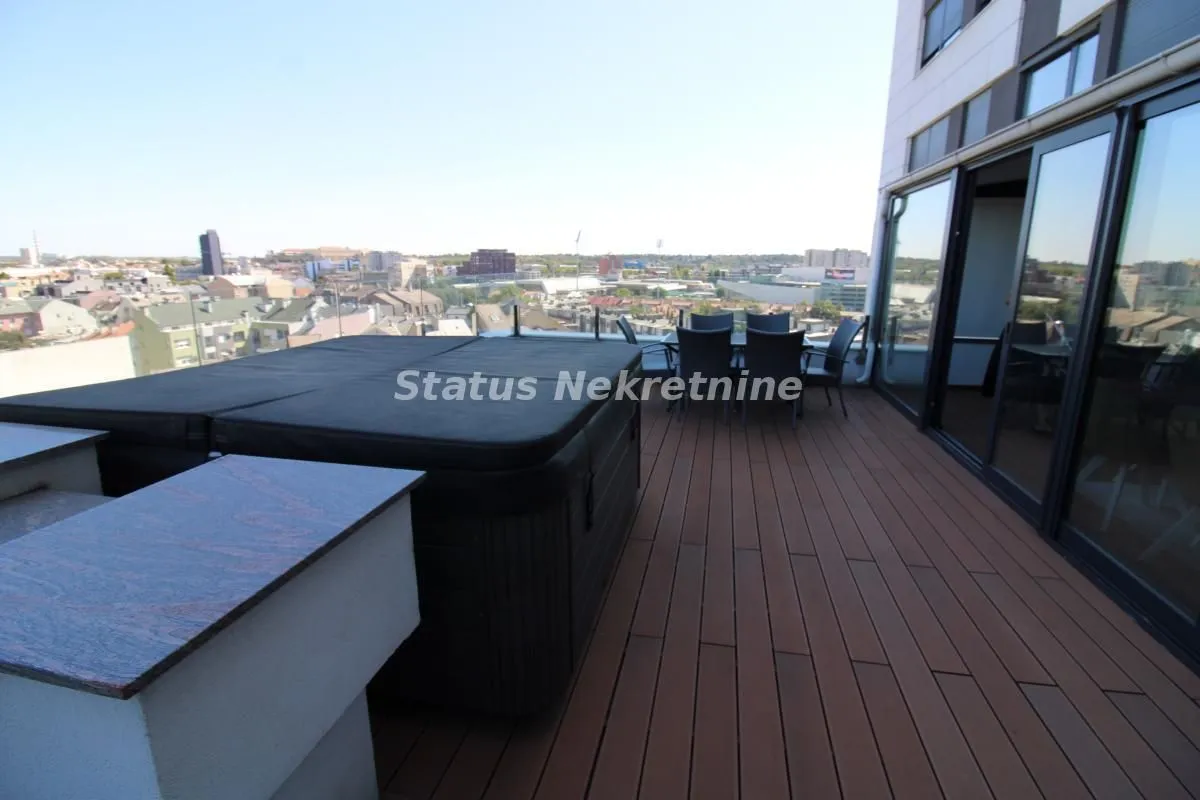 Spacious terrace with a jacuzzi and city view.