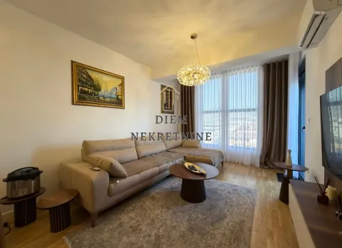 Living room with a sofa, coffee table, and large window. - image 2