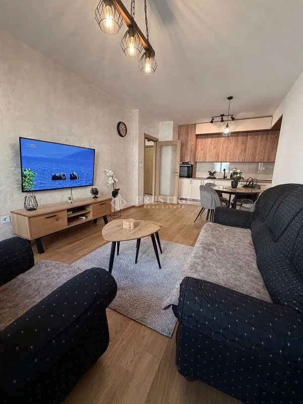 Living room connected with dining area and kitchen.