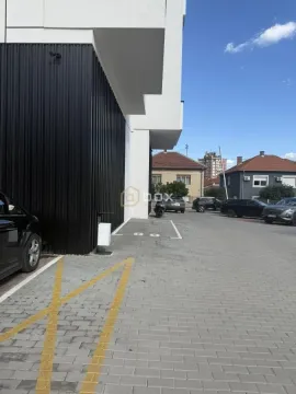 View of the exterior of the building and parking area. - image 3