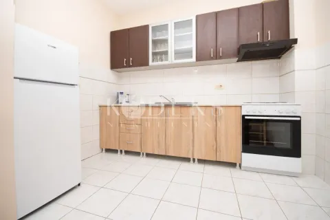 Kitchen with wooden cabinetry, a white refrigerator, and a white stove. - image 4