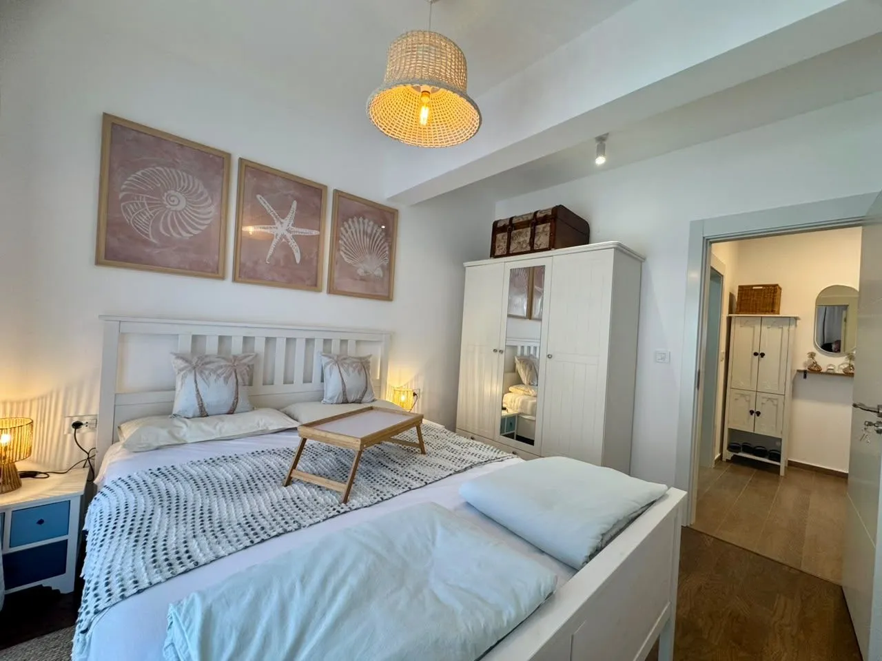 Bright and tidy bedroom with a double bed and wardrobe.
