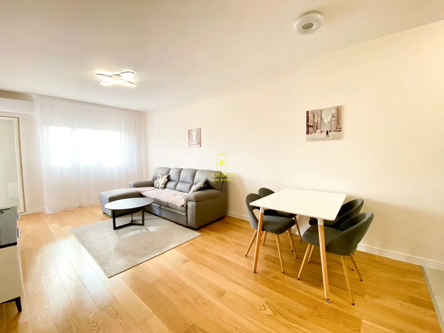 Living room with a sofa and a dining table.