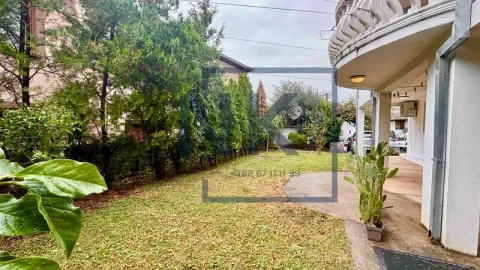 View of the landscaped yard and part of the house with a balcony. - image 12