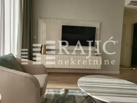 Modern living room with a sofa, TV, and coffee table. - image 2
