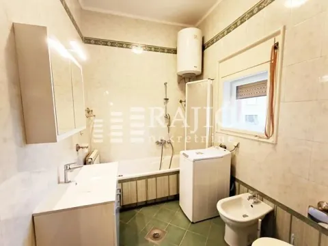 Fully equipped bathroom with a bathtub and washing machine. - image 5