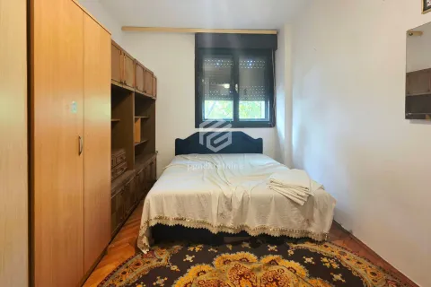 Bedroom with a double bed, wooden wardrobe and a rug. - image 9