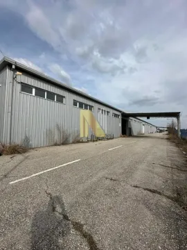 Exterior of an industrial building with large warehouse space and paved yard. - image 5