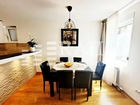 Dining area with a table and black chairs in a modern apartment. - image 5