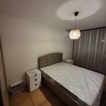 Bedroom with a double bed, nightstands, and a pendant lamp. - image 12