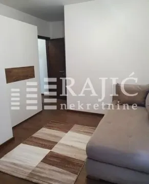 Furnished bedroom with a bed, wardrobe, and carpet. - image 9