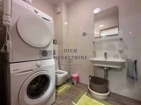 Bathroom equipped with plumbing fixtures, a sink, a mirror, and a washer and dryer. - image 11