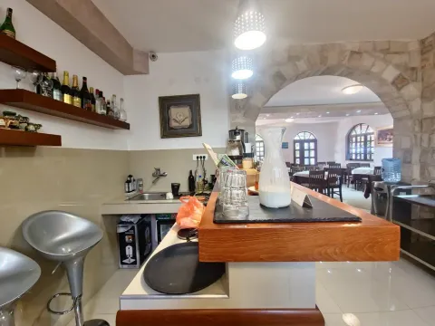 Bar counter with a sink and drink shelves inside a restaurant interior. - image 5