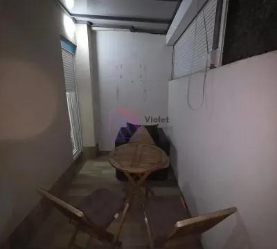 Covered terrace furnished with a small wooden table and chairs. - image 16