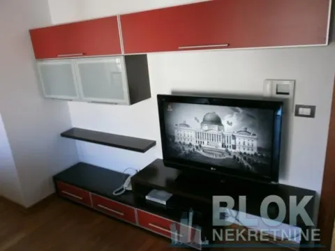 Living room with a TV and wall units. - image 12