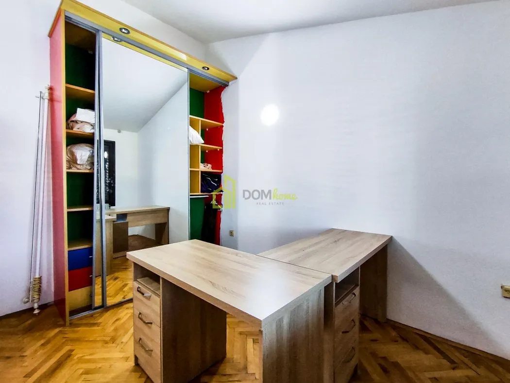 Children's room with a desk and a large wardrobe.