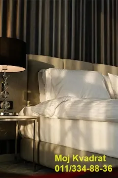 Modern bedroom with a double bed and a nightstand. - image 8