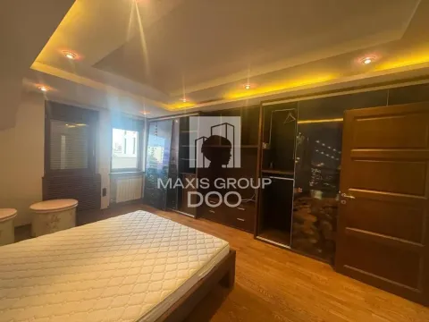 Bedroom with a double bed and built-in wardrobes. - image 7
