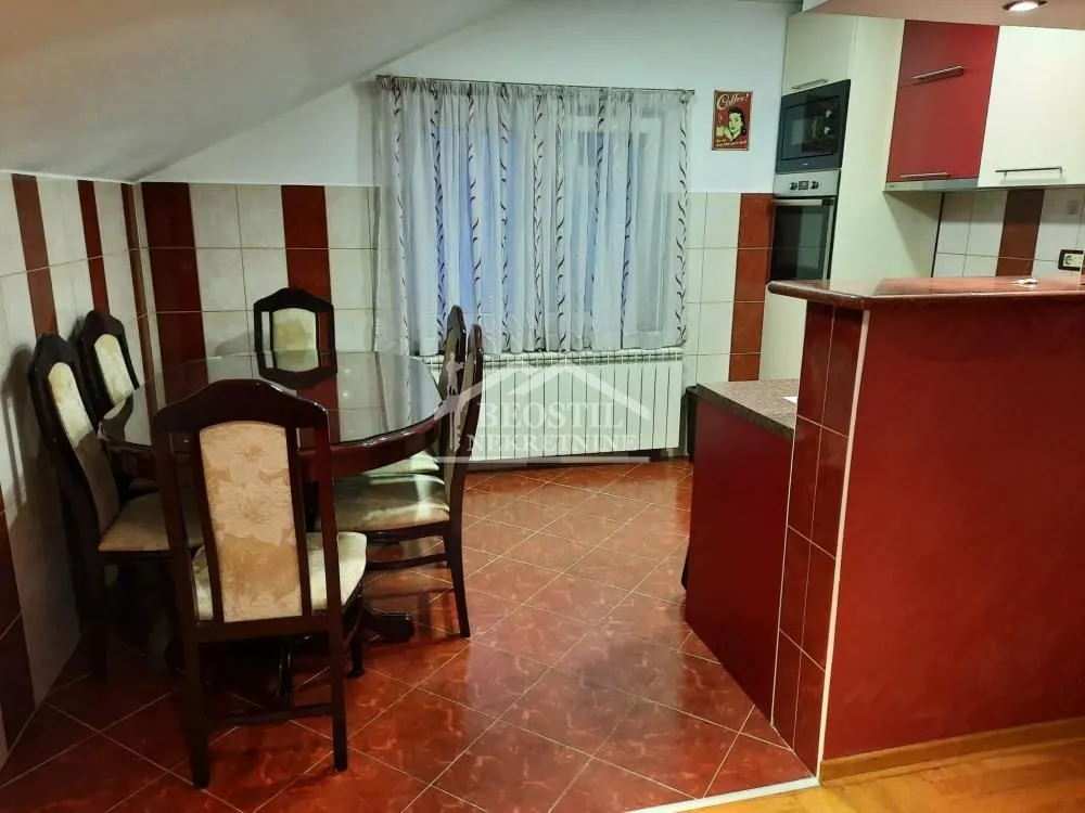Kitchen with a dining area and a wooden table with chairs.