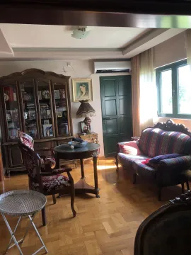 A living room featuring classic wooden furniture, a sofa, and parquet flooring. - image 11