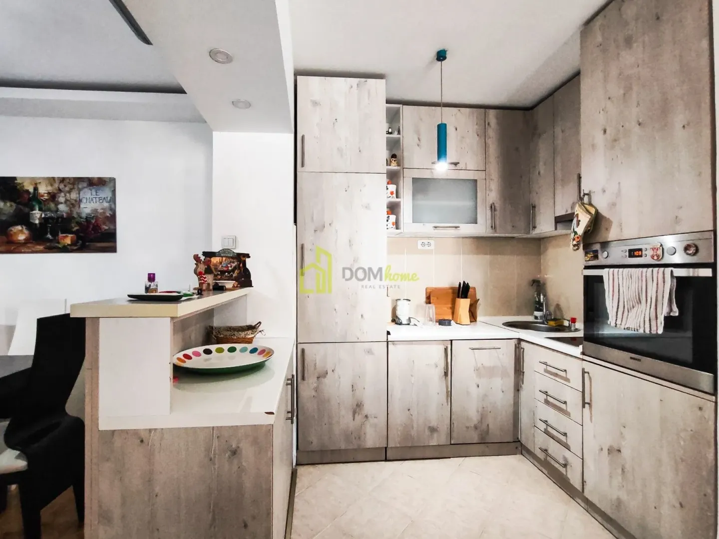 Small kitchen with wooden finish cabinets and a built-in oven.