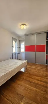 Bedroom with a bed, large wardrobe and wooden flooring. - image 8