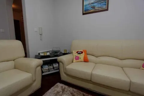 Living room featuring light leather sofas and a small side table. - image 6