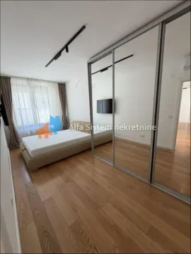 Spavaća soba sa bračnim krevetom i velikim ugrađenim ormarom sa ogledalima. - image 7