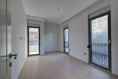 Empty bright room with hardwood floors and balcony doors. - image 2