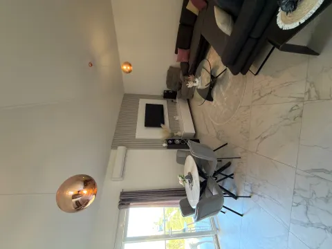Living room with dining area and modern furniture. - image 10