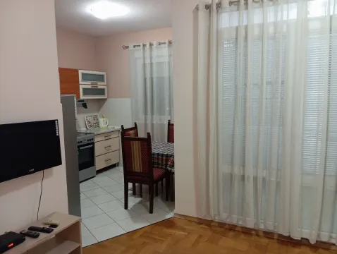 Manja kuhinja sa trpezarijskim stolom i pogledom na unutrašnjost stana. - image 2