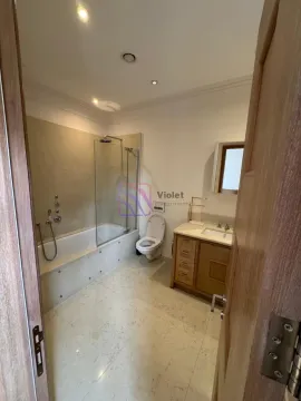 Bathroom with bathtub, shower screen, toilet and wooden vanity. - image 18