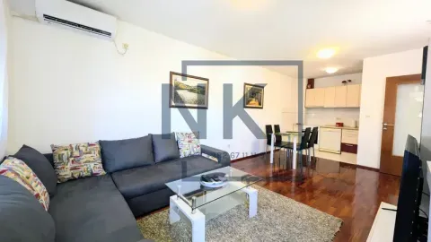 Living room with a corner sofa and a dining area in the background. - image 4