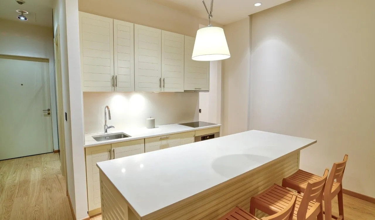 Modern kitchen with a breakfast bar and built-in appliances.