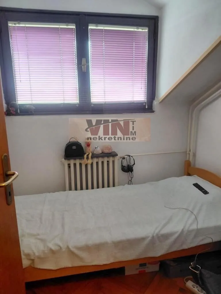 Smaller bedroom with a bed and a window.